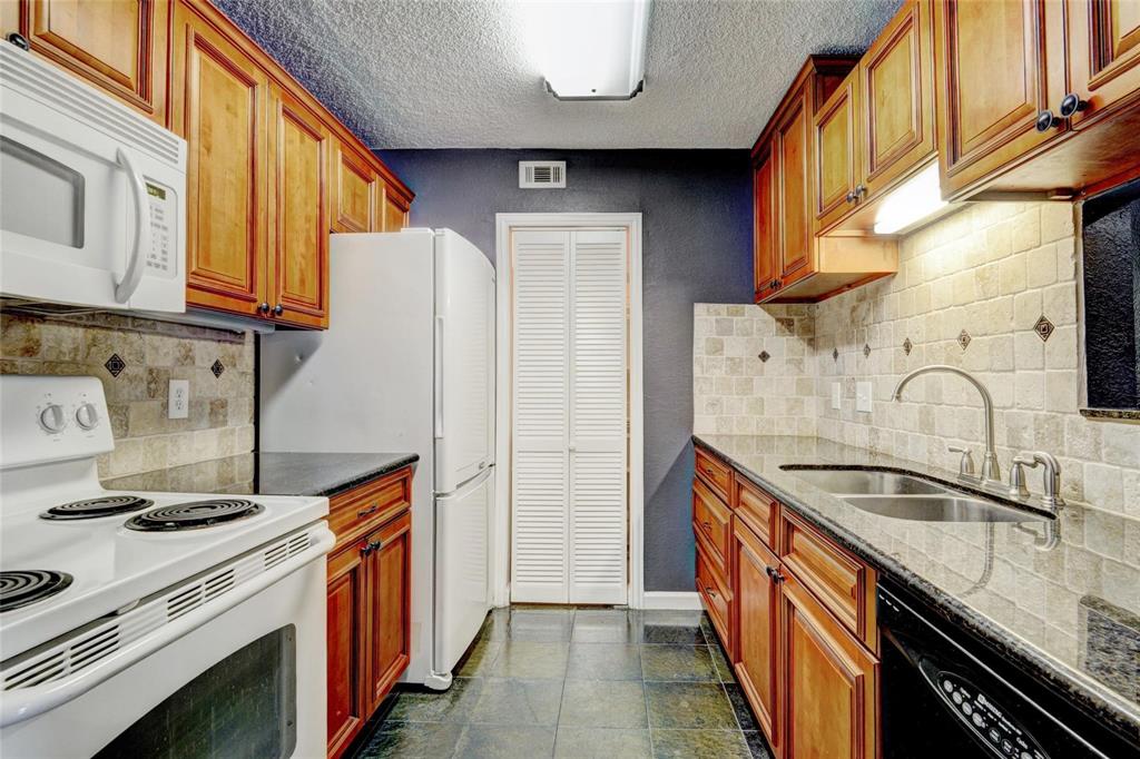 a kitchen with stainless steel appliances granite countertop a sink and a stove