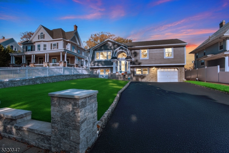 a front view of a house with a garden and yard