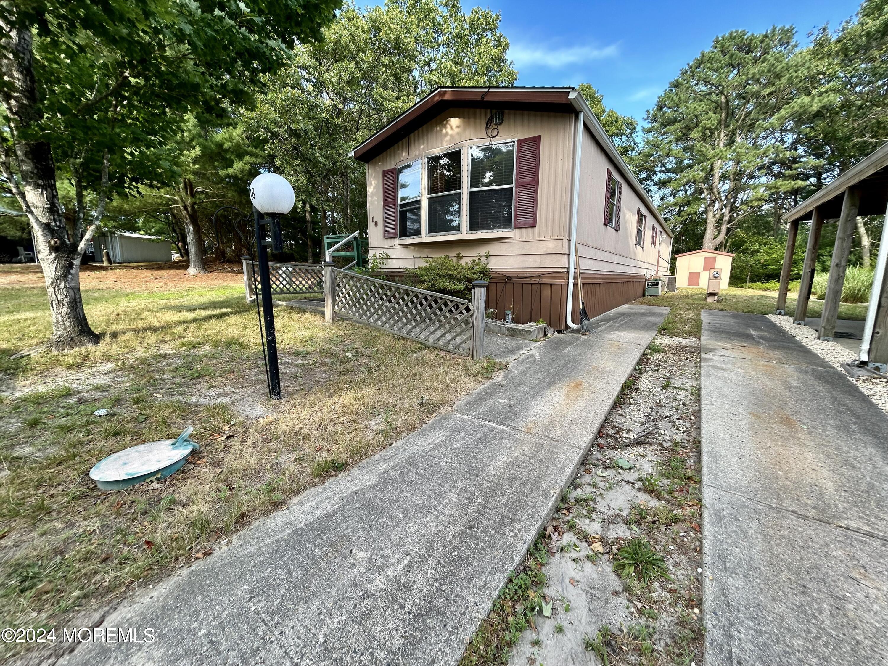 a front view of a house with a yard and trees