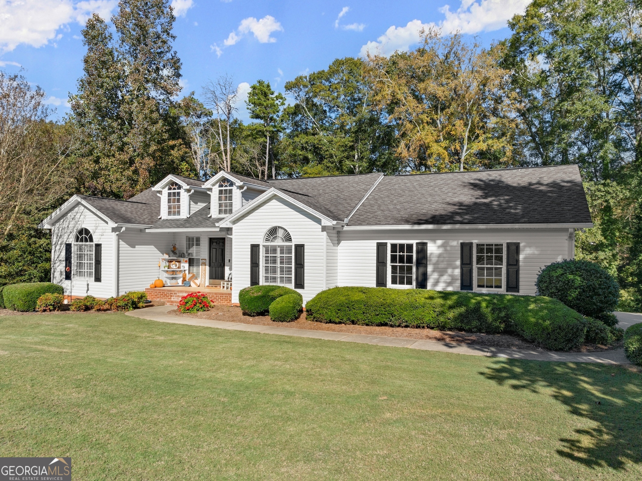 a front view of a house with a yard