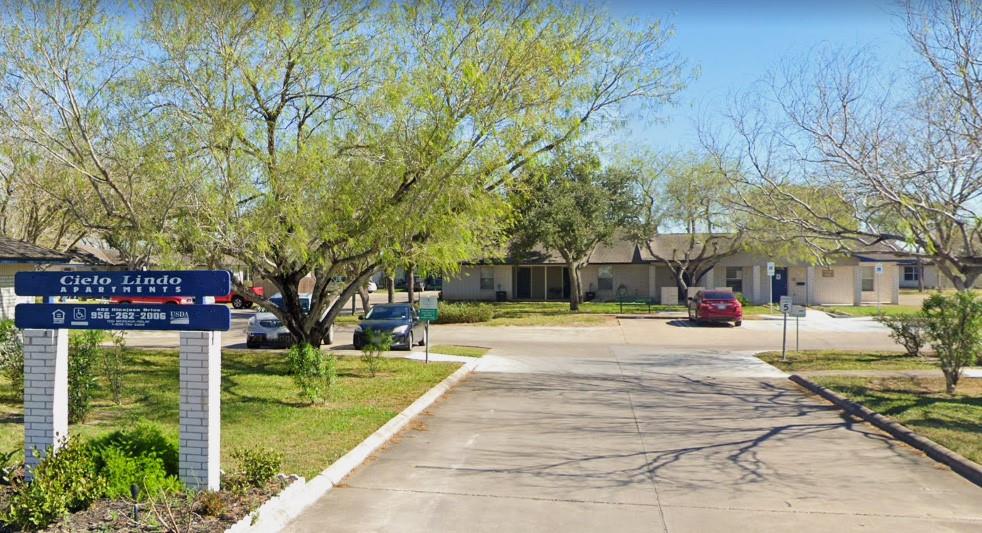 a sign board with yard in the back