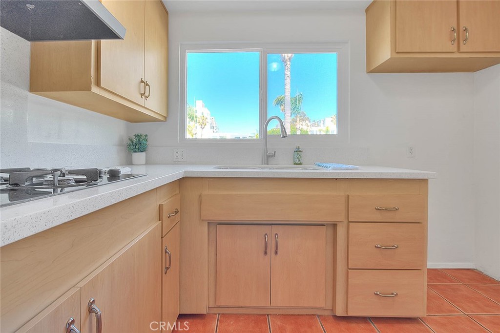 a kitchen with a sink cabinets and window