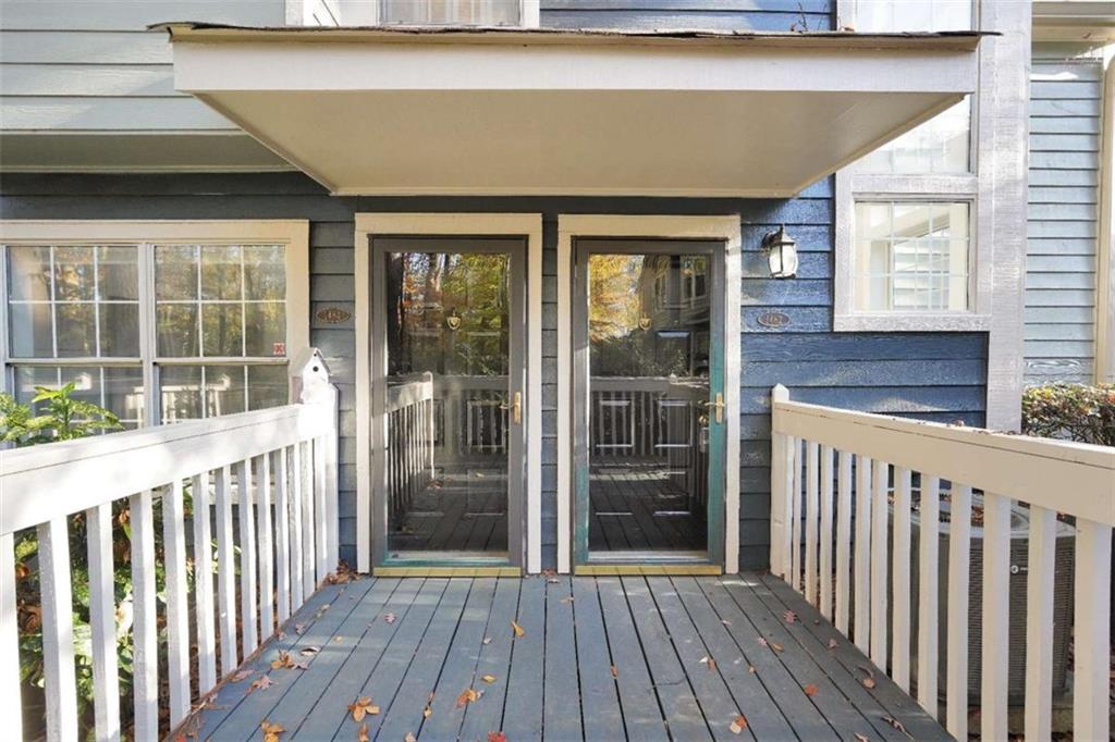 a view of a house with wooden deck