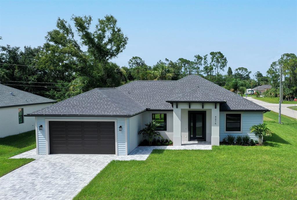 a front view of a house with a garden