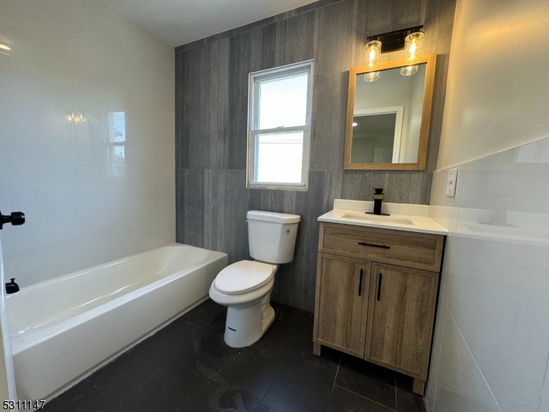 a bathroom with a sink toilet and bathtub