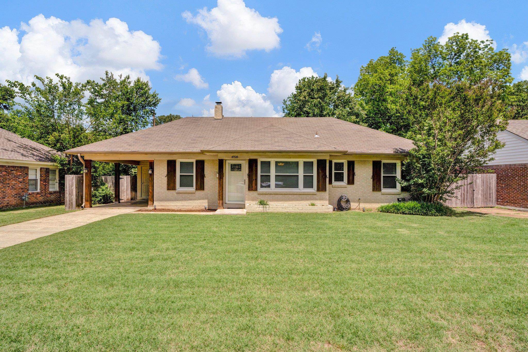 a front view of a house with a garden