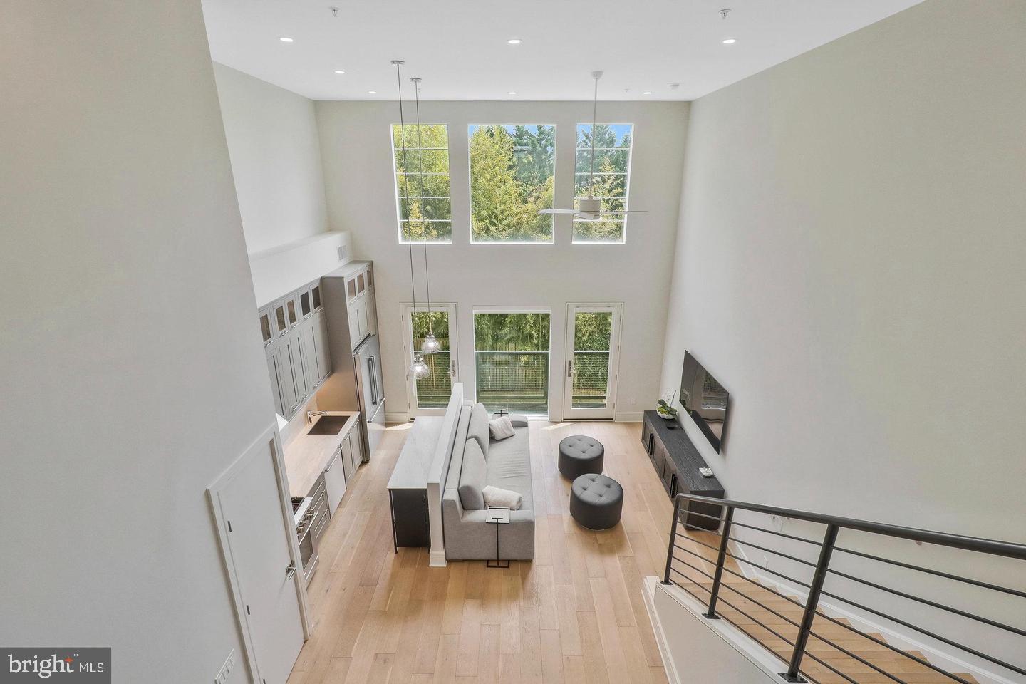 a view of a living room with furniture and a large window