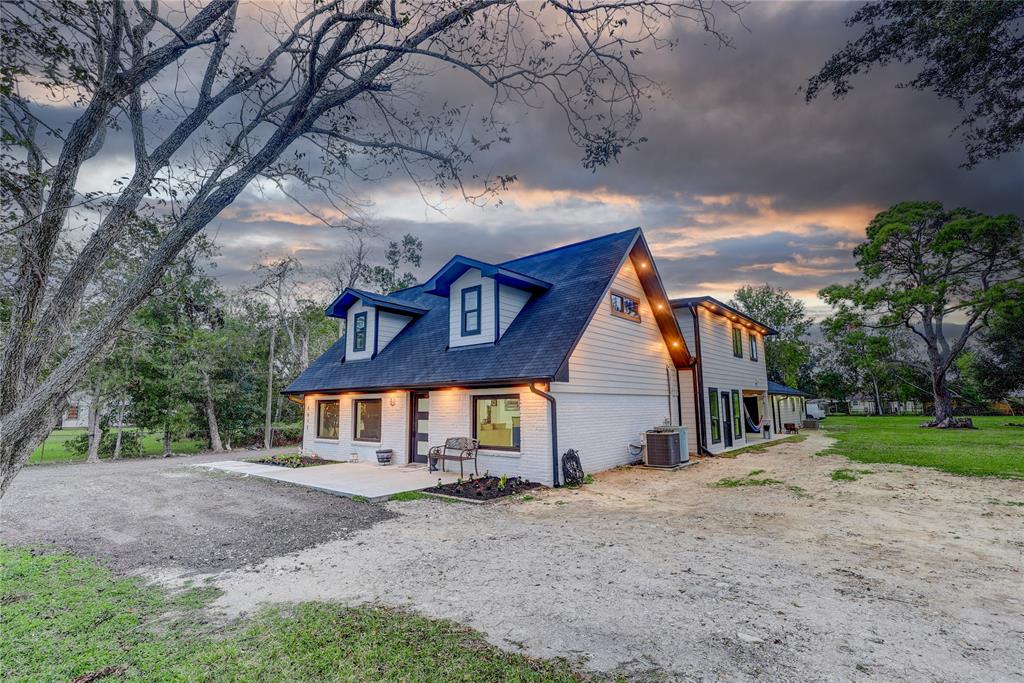 Charming two-story home with a modern, rustic design, surrounded by lush greenery. It features a spacious yard, inviting front porch, and large windows for natural light. Ideal for those seeking a serene and picturesque living environment.