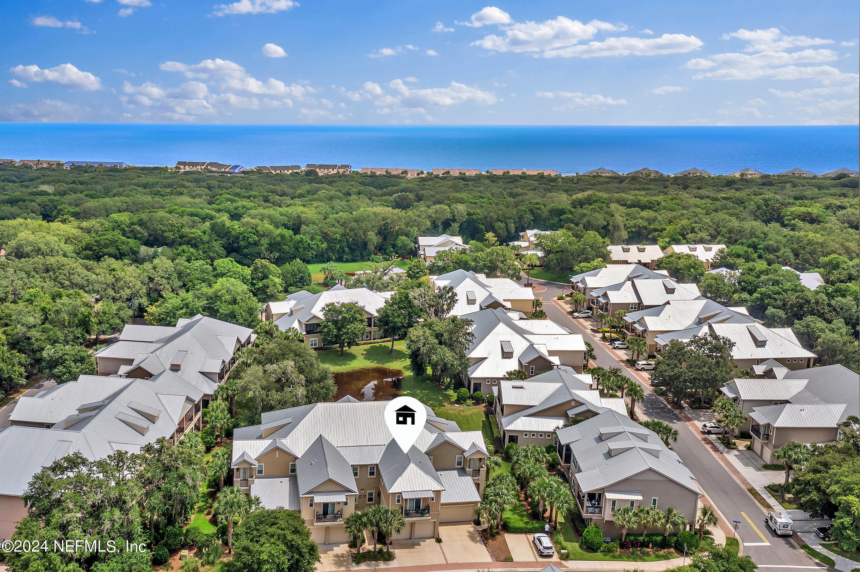 an aerial view of residential houses with outdoor space and street view