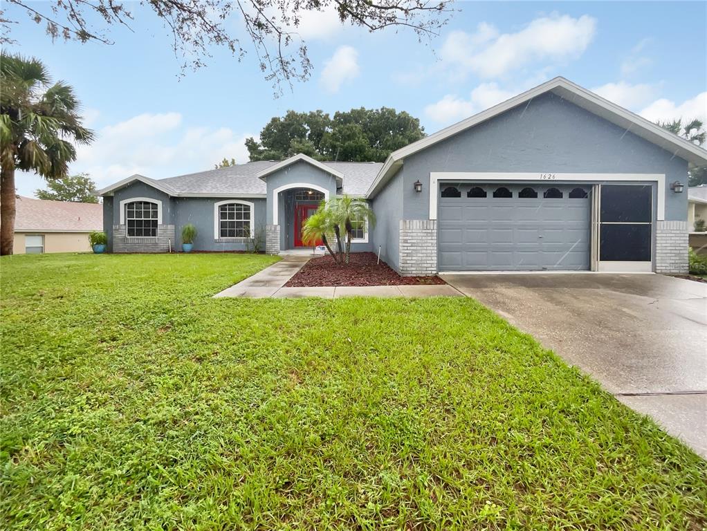 a front view of a house with a yard and garage