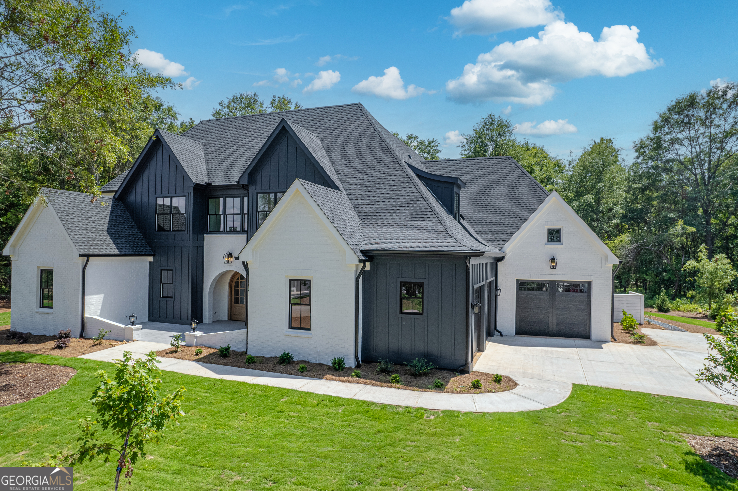 a front view of a house with a yard garage and outdoor seating