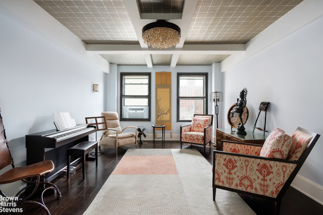 a bedroom with furniture and a large window