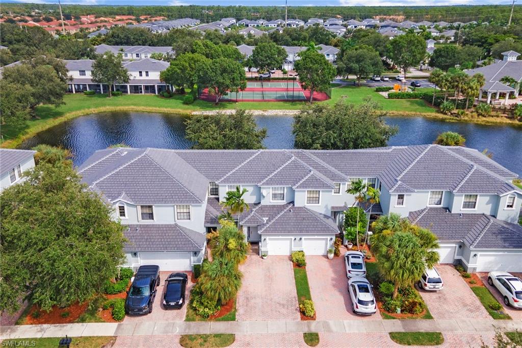 an aerial view of a house with a garden and lake view