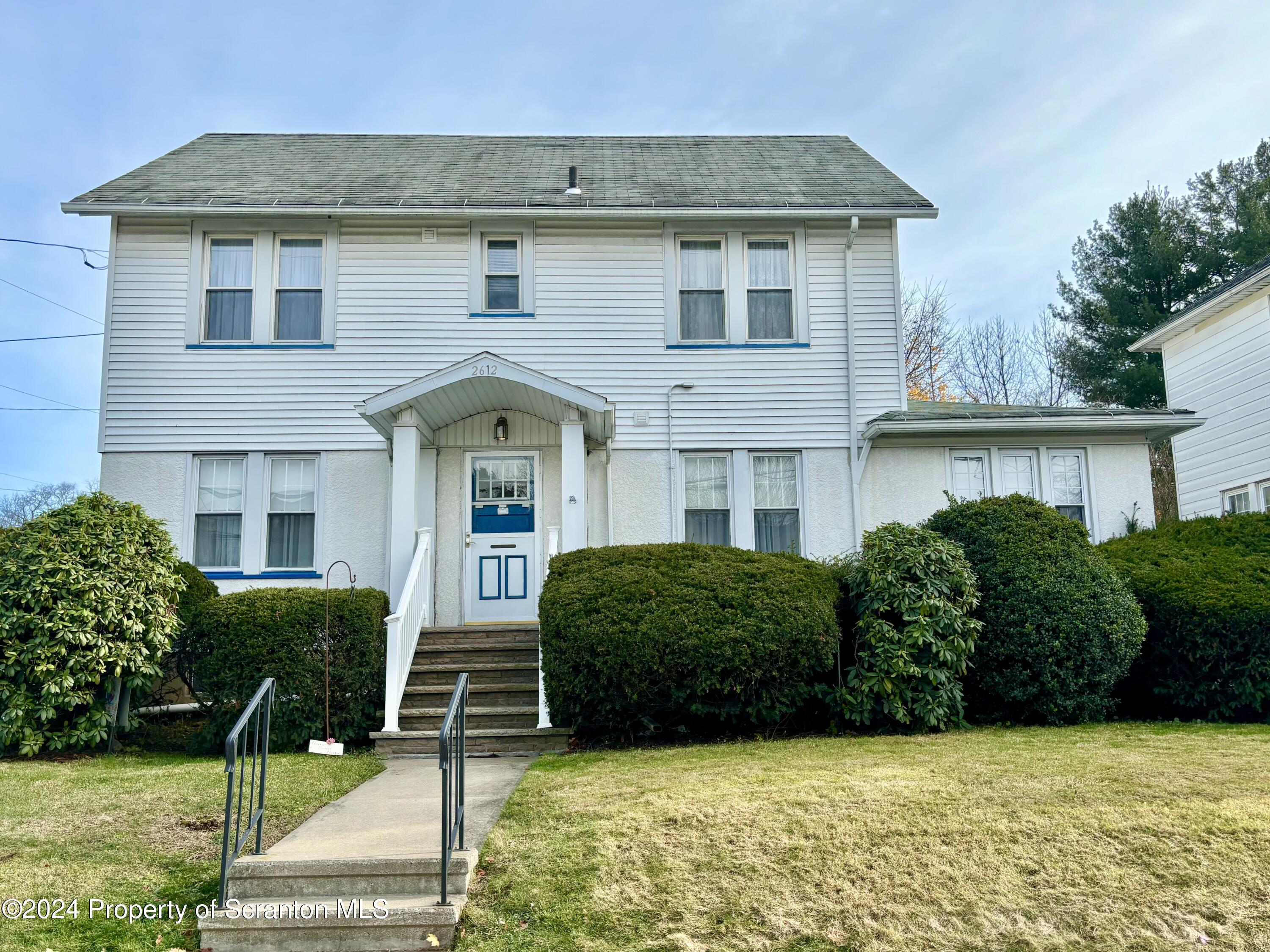 a front view of a house with garden