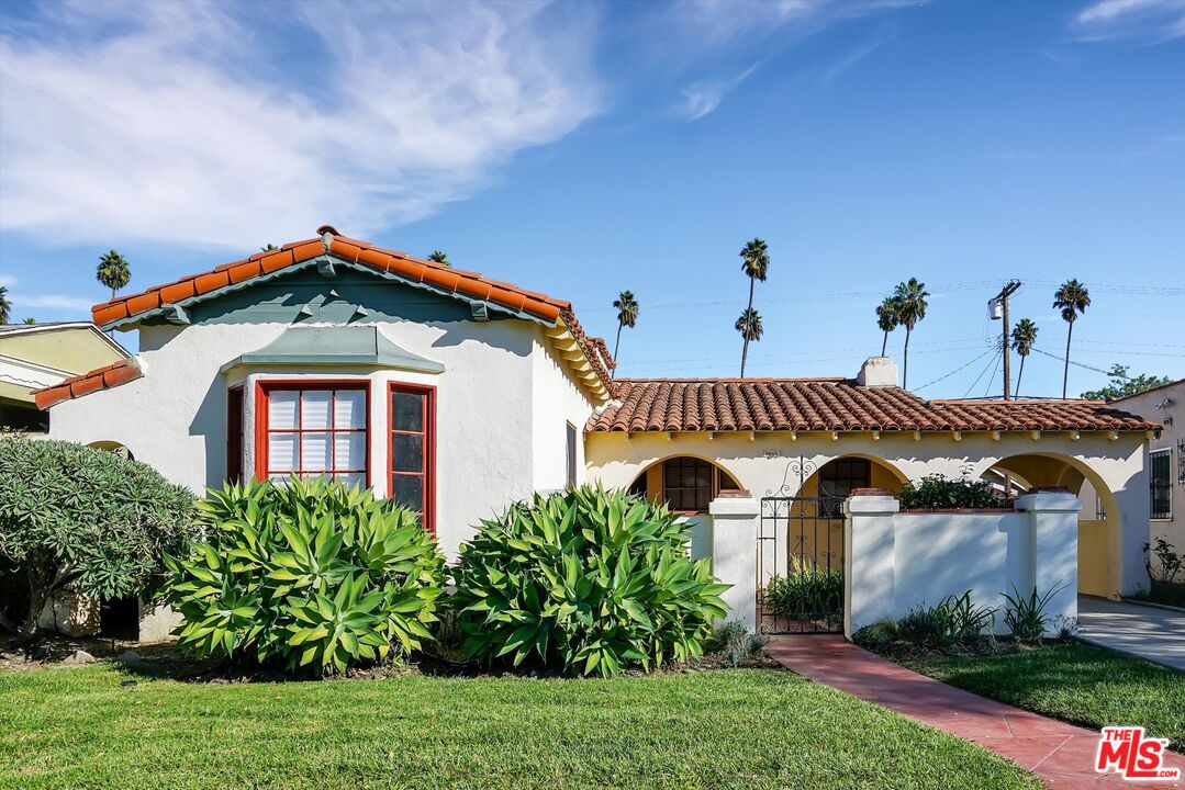 a front view of a house with a garden