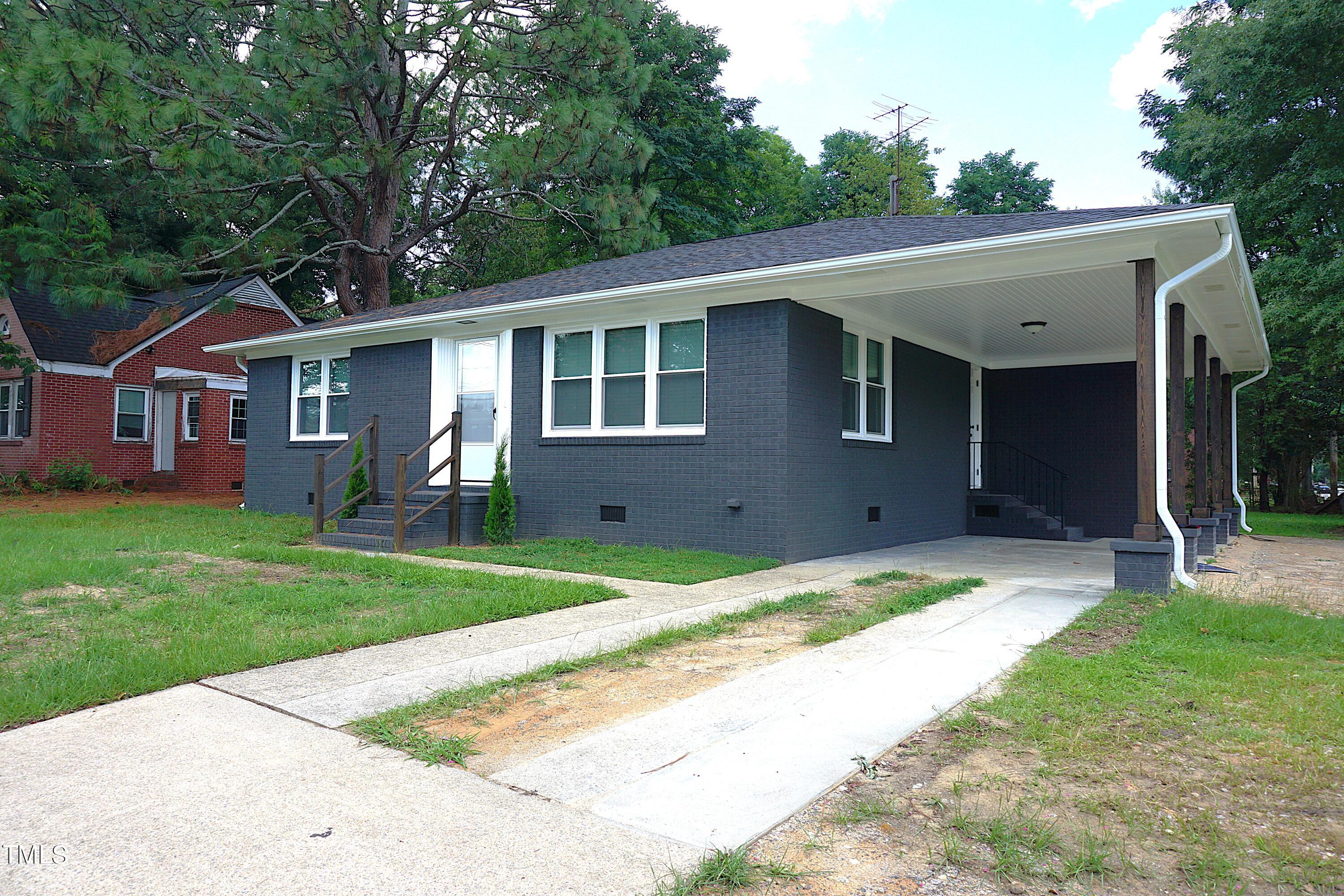 a backyard of a house with yard and barbeque oven