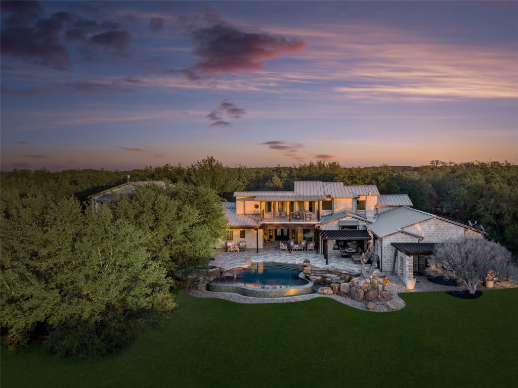 an aerial view of a house with swimming pool garden and lake view