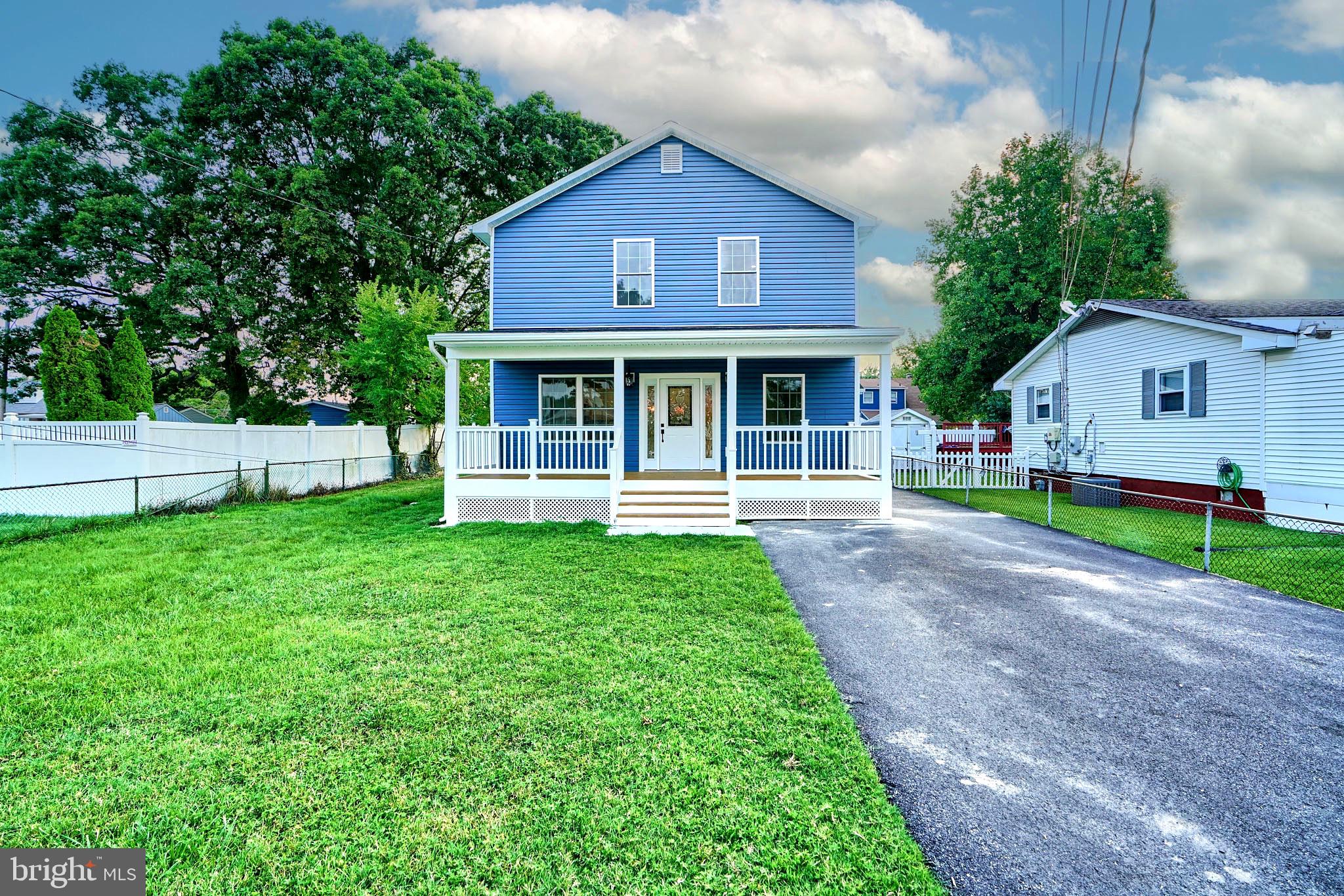 a front view of a house with a garden and yard