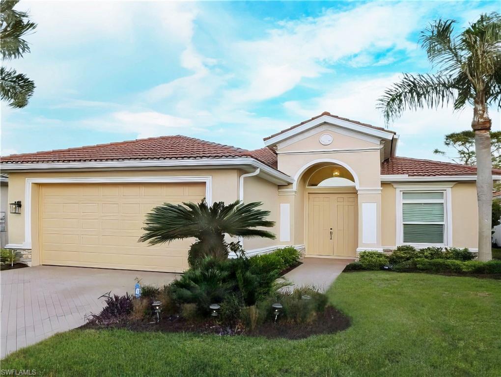 View of front of property featuring a front yard and a garage