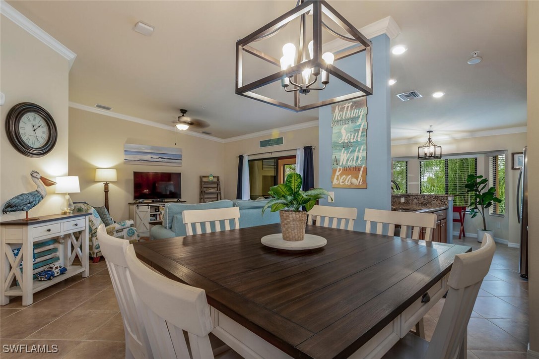 a view of a dining room with furniture and a chandelier