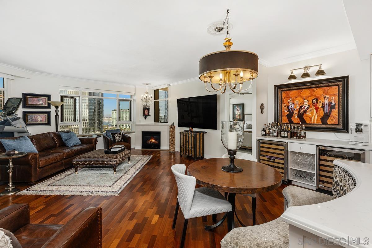 a living room with furniture a flat screen tv and kitchen view