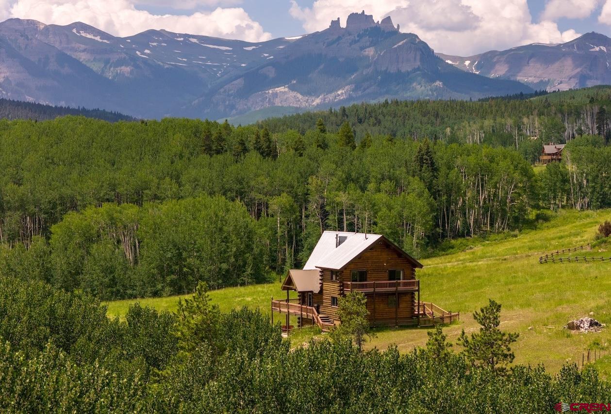 a aerial view of a house with mountain view