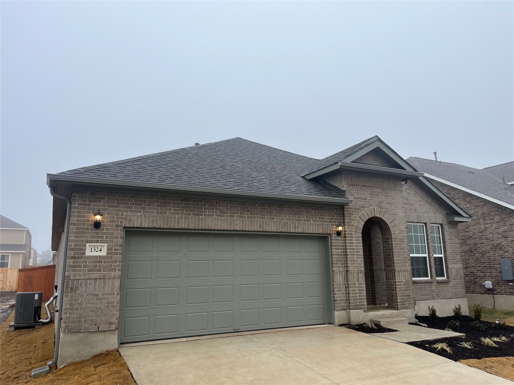 a front view of a house with garage