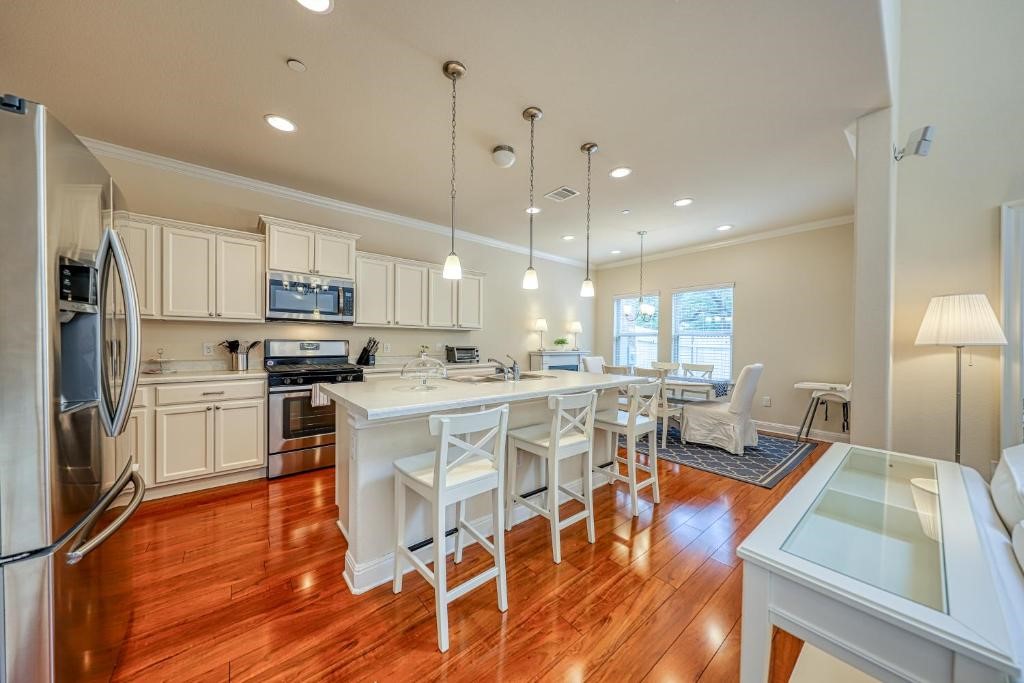 a large kitchen with a table and chairs