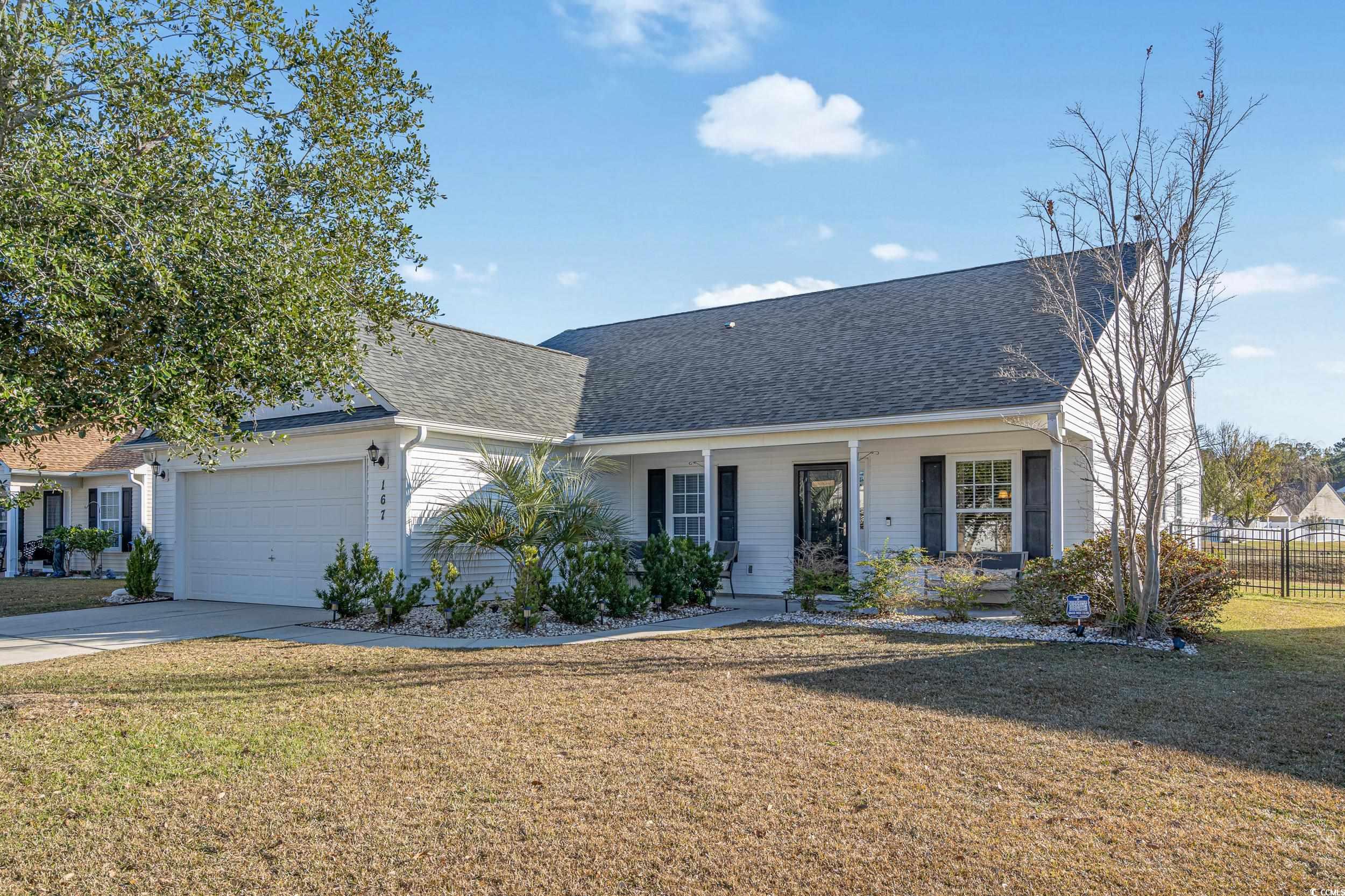 View of front of house featuring a porch, a garage