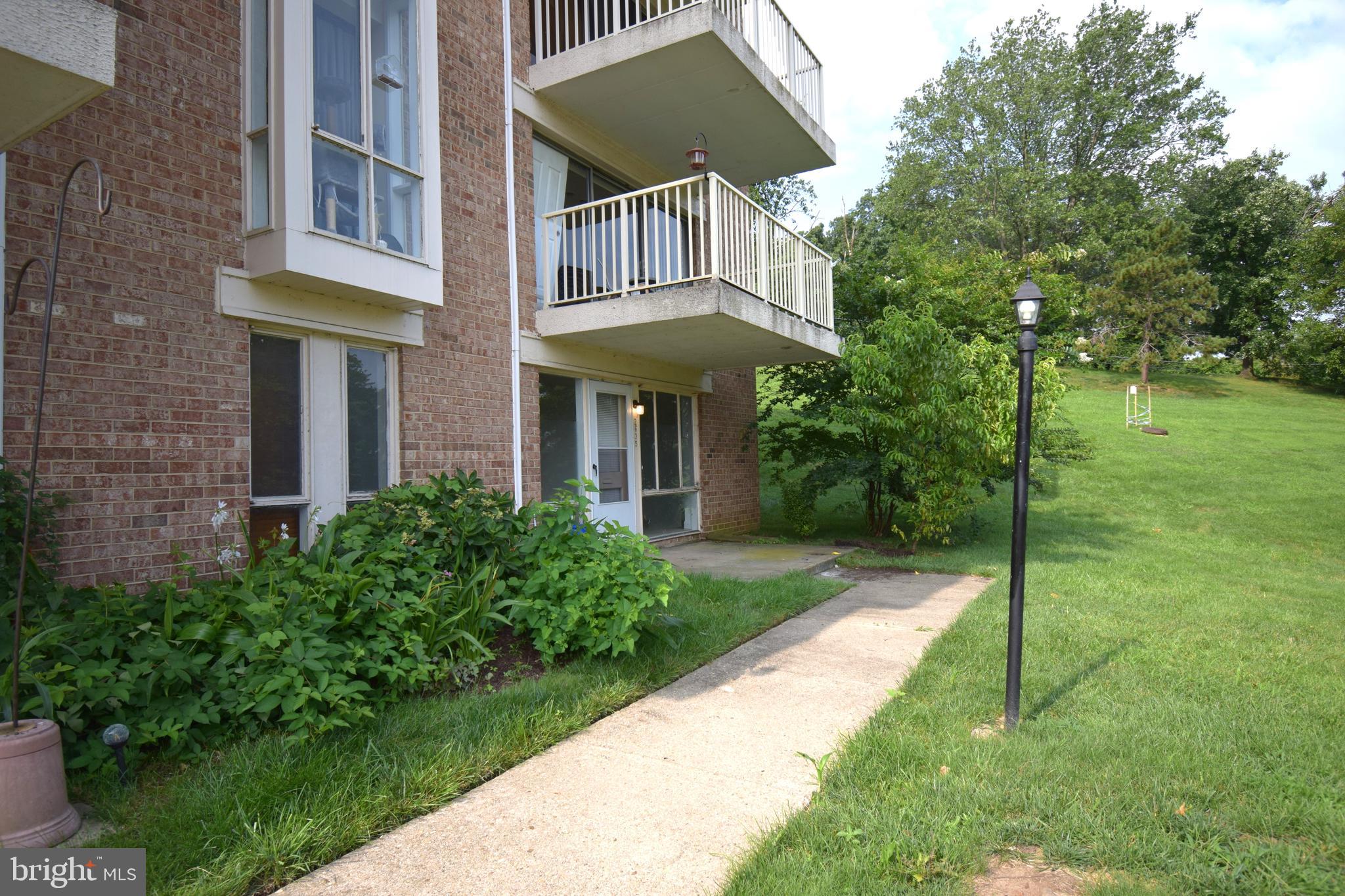 a view of a brick house with a yard