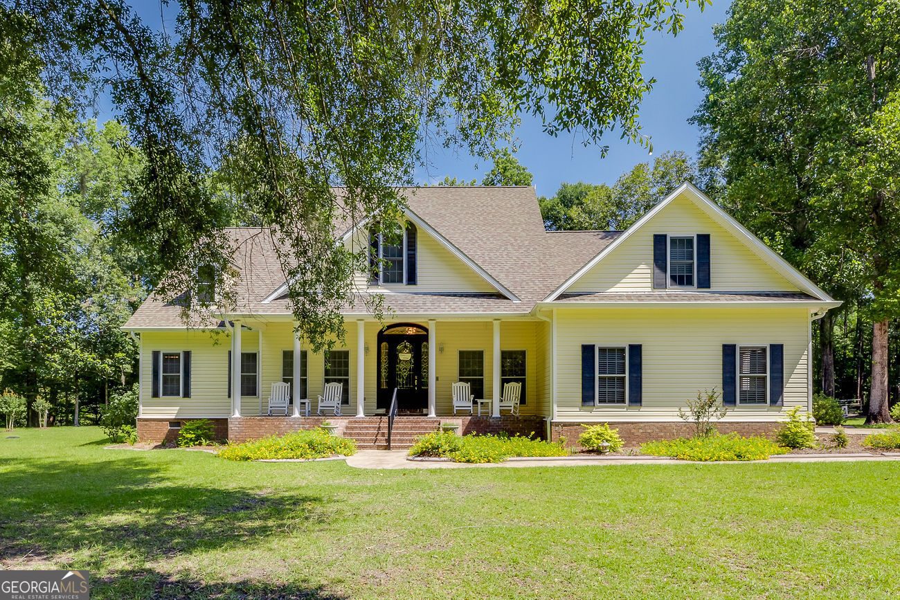 a front view of a house with a garden