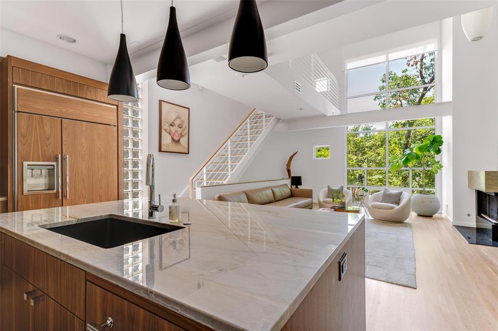 a kitchen with a sink a counter top space and stainless steel appliances