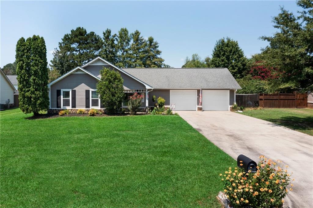 a front view of a house with a garden