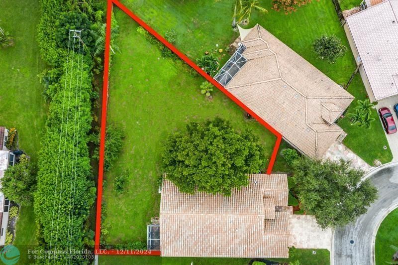 an aerial view of a house with a yard and outdoor seating