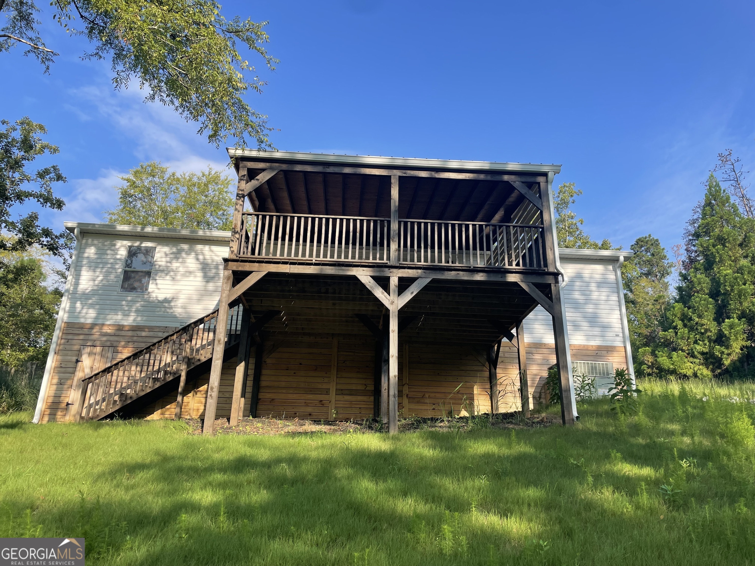 a view of a deck with a big yard