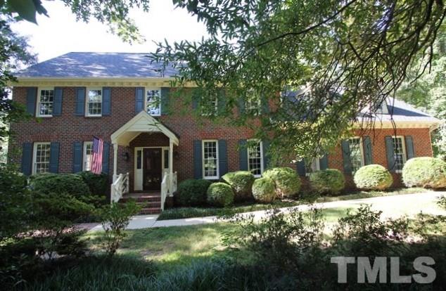 a front view of a house with a yard and porch