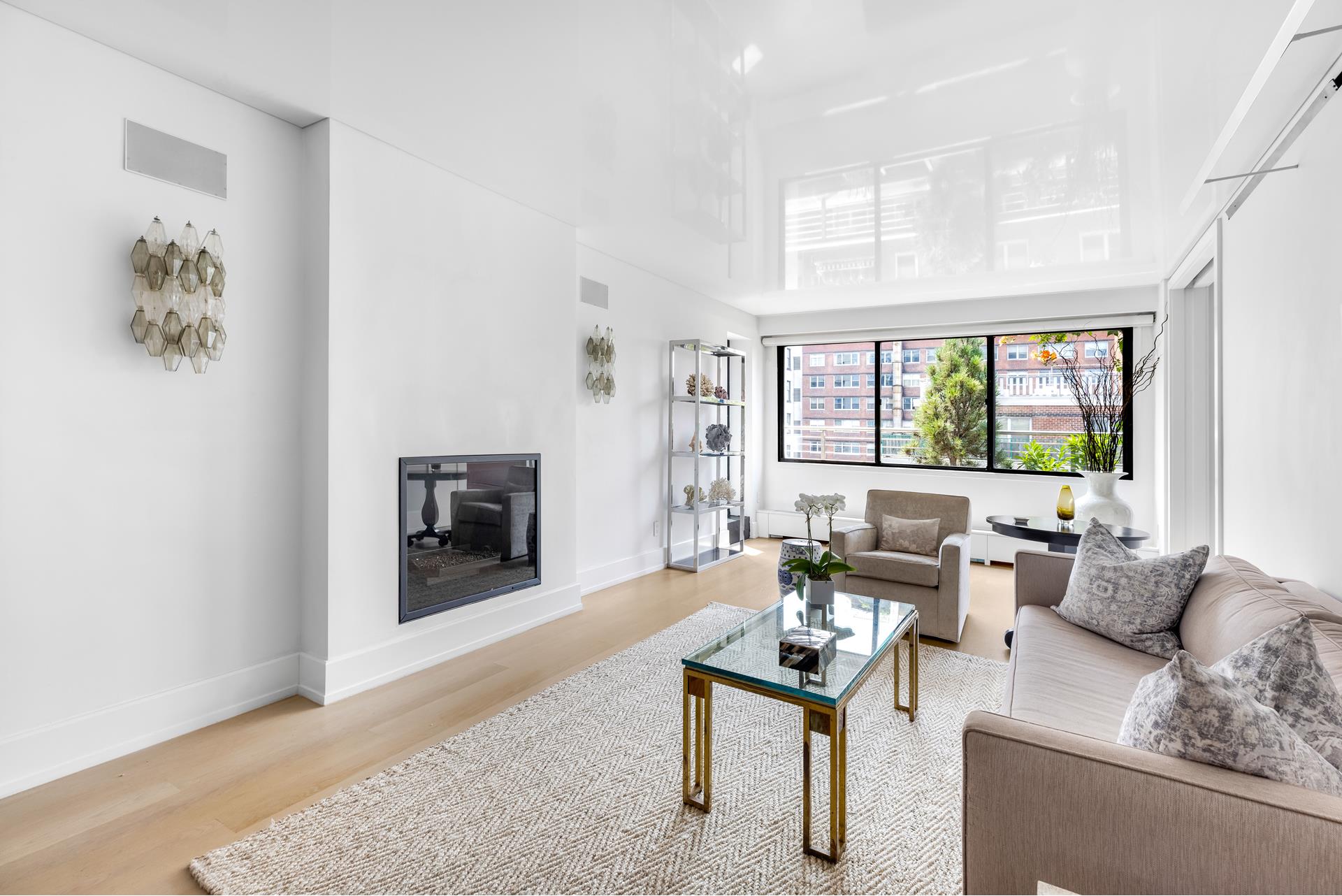 a living room with furniture a large window and a fireplace