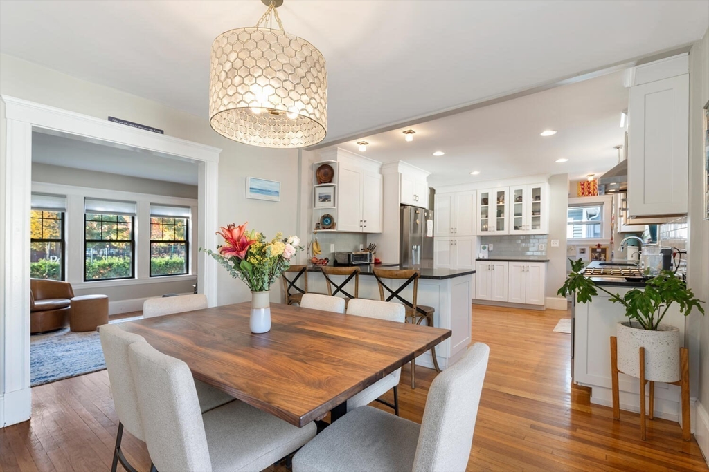 a living room with furniture dining table and wooden floor