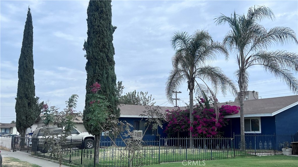 a front view of multiple houses with yard