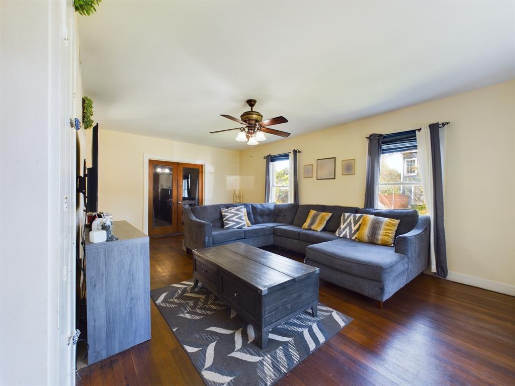 Welcome home to Crocket Street in Galveston! Step into the formal living space, filled with natural light, offering a welcoming atmosphere where everyone can unwind and relax.