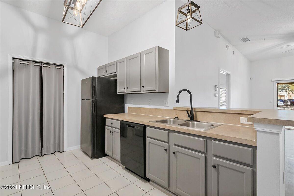 a kitchen with stainless steel appliances granite countertop a sink and a refrigerator