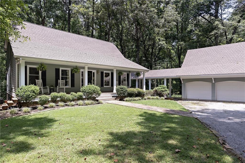 a front view of a house with a yard and porch