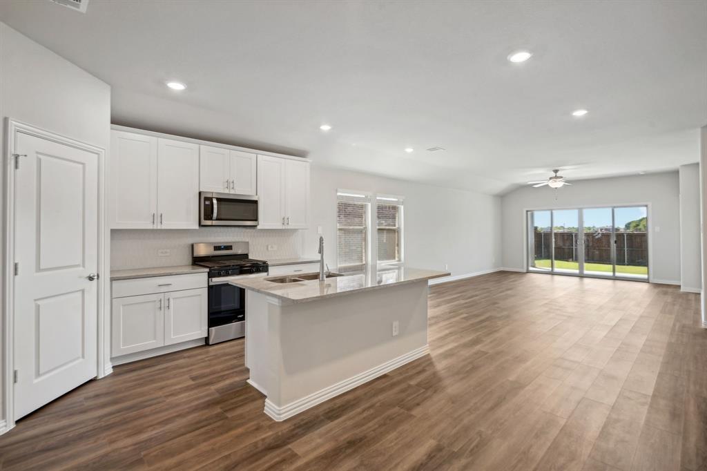 a view of kitchen with sink and wooden floor