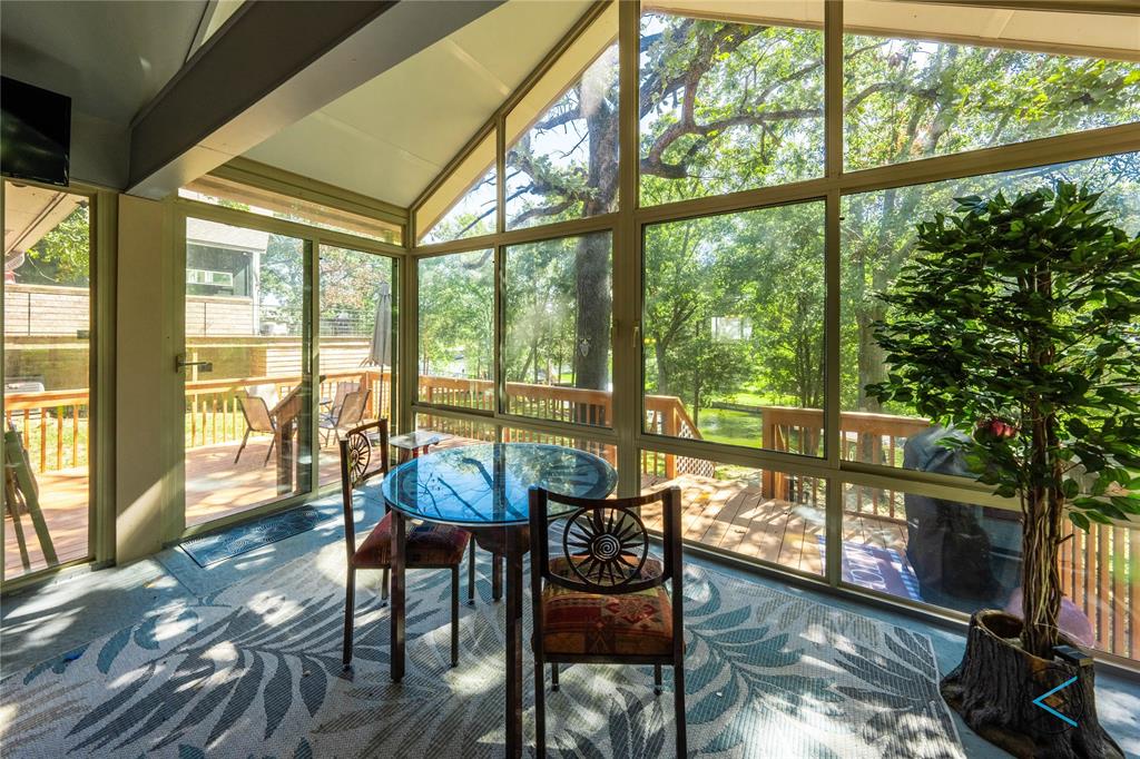 a living room with large windows and wooden floor