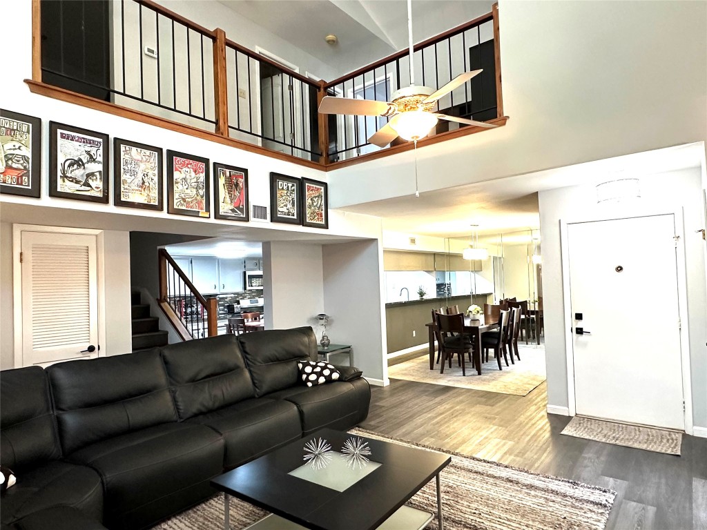 a living room with furniture and a floor to ceiling window