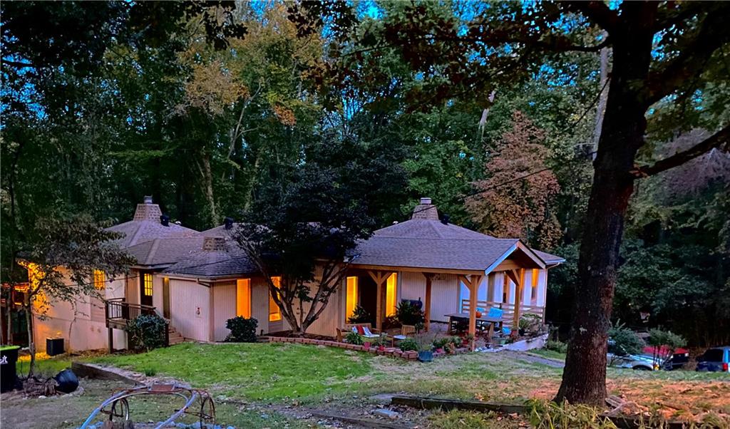 a view of a big house in front of a big yard with large trees