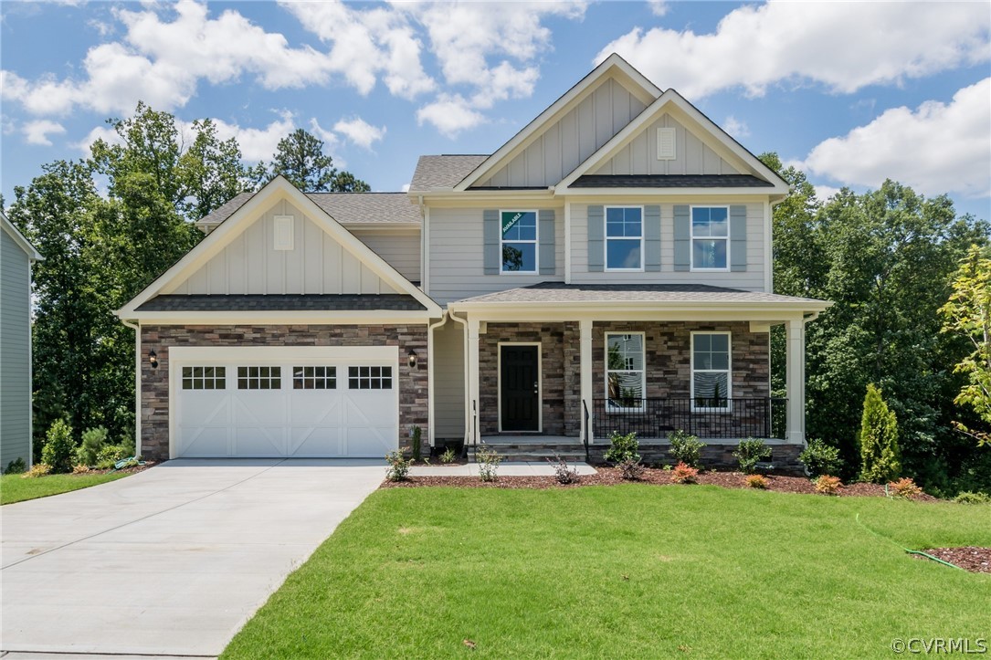 a front view of a house with yard and green space