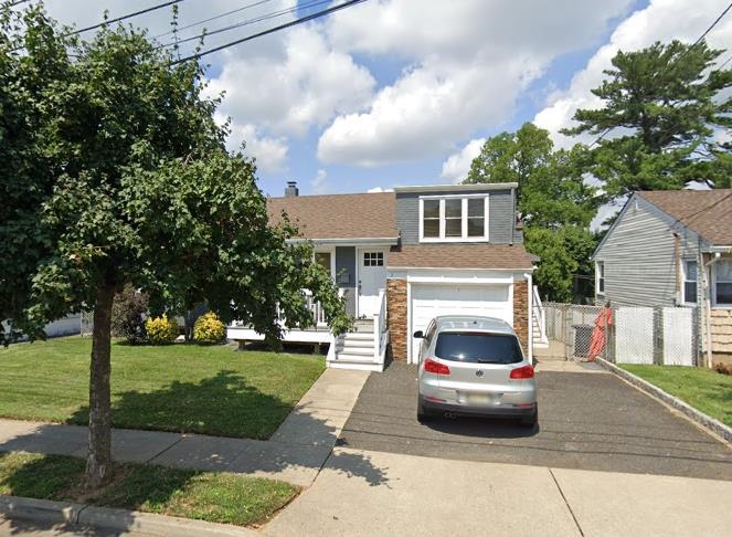 a white car parked in front of a house