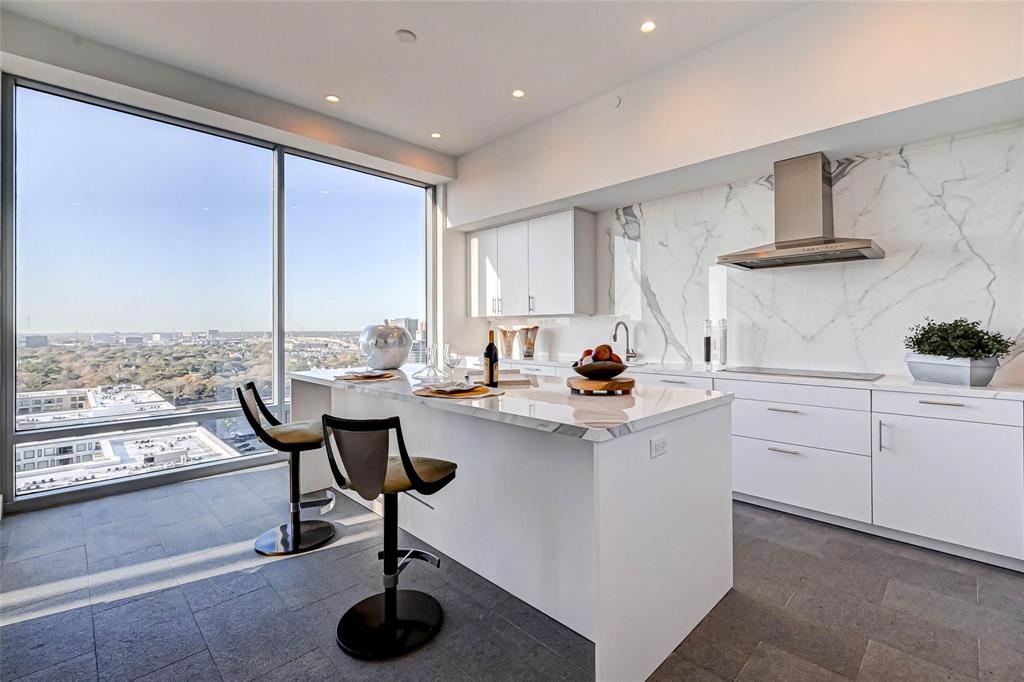 a kitchen with white cabinets and sink