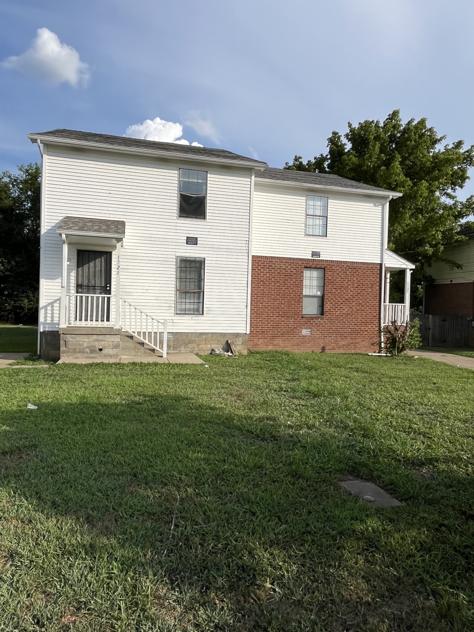 a front view of house with yard and green space